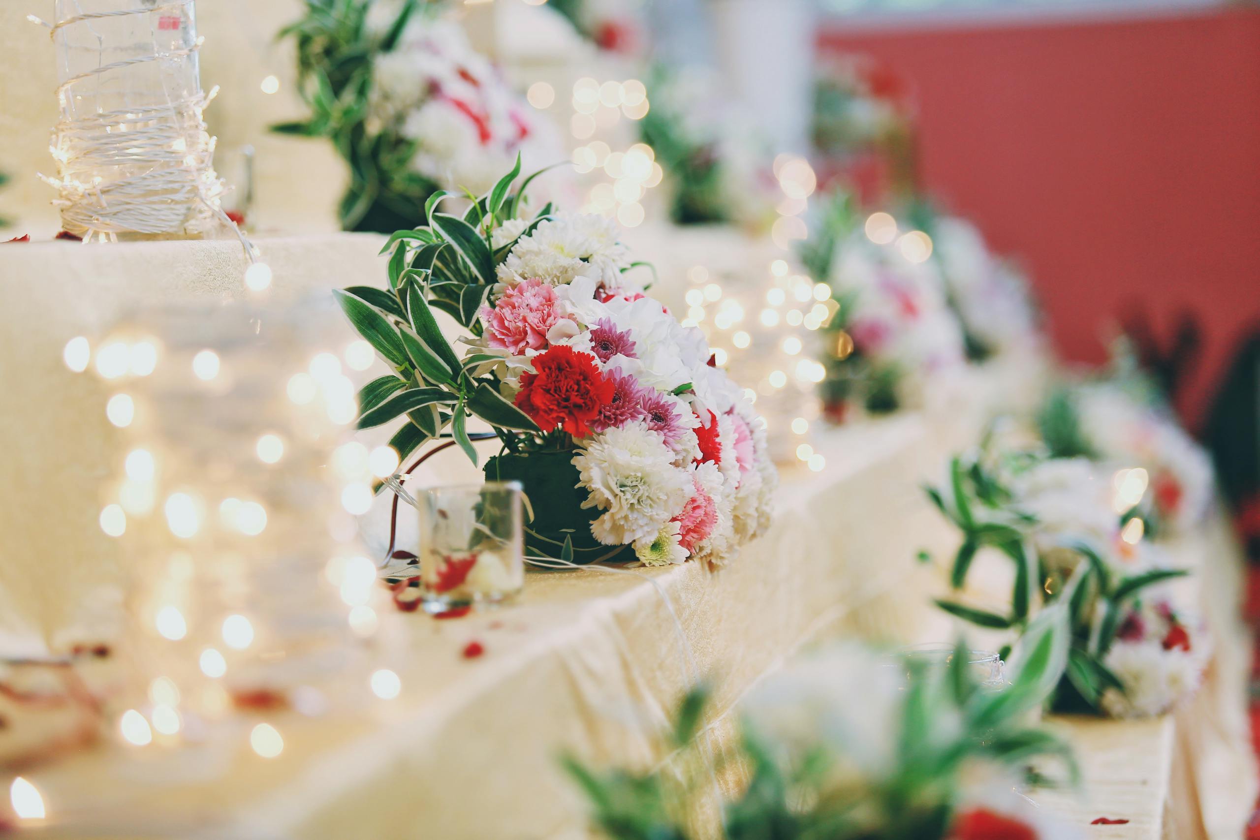 Elegant floral arrangements with warm lighting create a romantic ambiance, perfect for an Indian wedding setting.